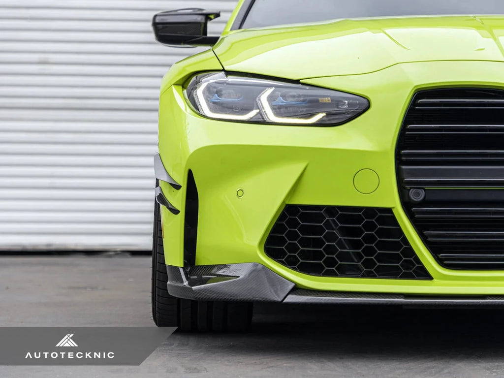 AutoTecknic G8X M3 M4 dry carbon canard set installed on exterior of car, showcasing aerodynamic enhancements and sleek carbon fiber design.
