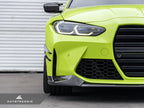 AutoTecknic G8X M3 M4 dry carbon canard set installed on exterior of car, showcasing aerodynamic enhancements and sleek carbon fiber design.