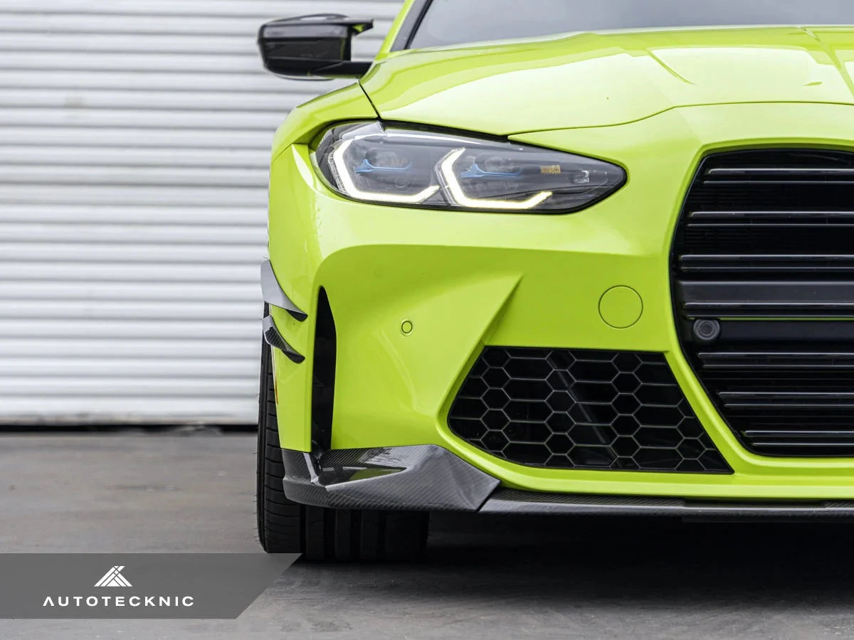 AutoTecknic G8X M3 M4 dry carbon canard set installed on exterior of car, showcasing aerodynamic enhancements and sleek carbon fiber design.