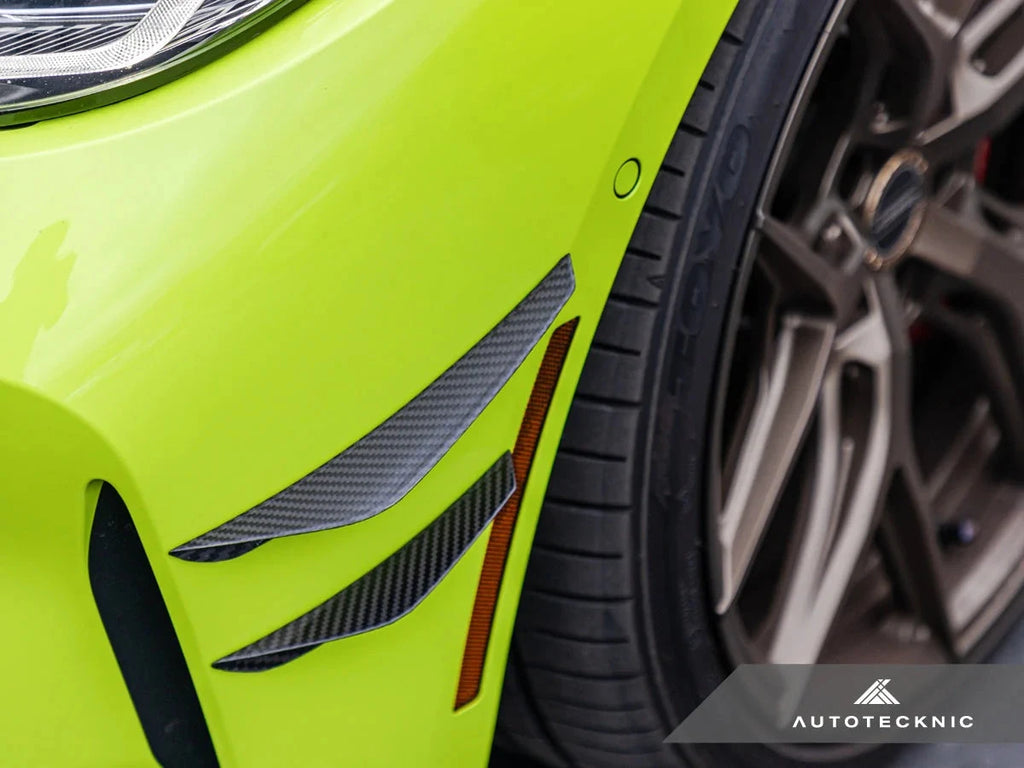 AutoTecknic G8X M3/M4 dry carbon canard set installed on an exterior car, showcasing lightweight aerodynamic enhancements.