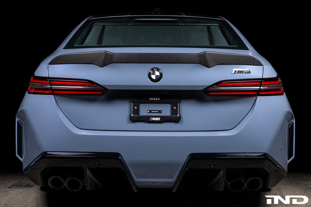Exterior IND Carbon BMW Roundel Set, black carbon fiber emblems for BMW vehicles, detailed close-up of the roundel logos.