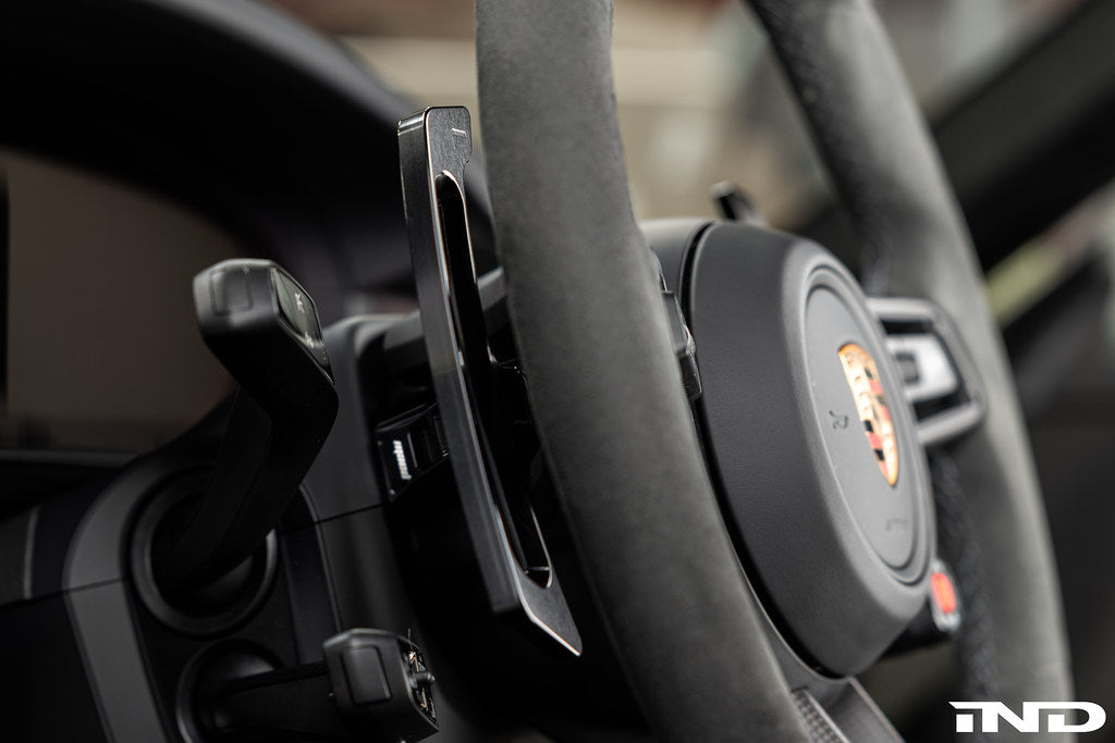 MAED Porsche 911 (992) billet magnetic shift paddle set installed in interior, featuring sleek metal design and ergonomic shape.