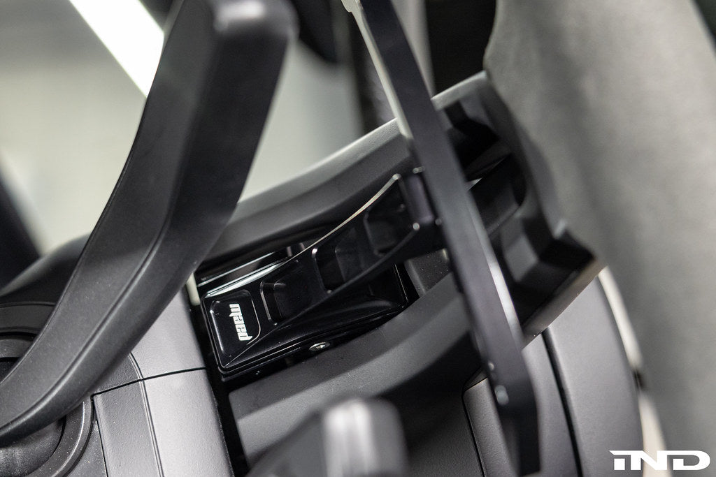 MAED Porsche 911 (992) billet magnetic shift paddles installed in the interior of the sports car.