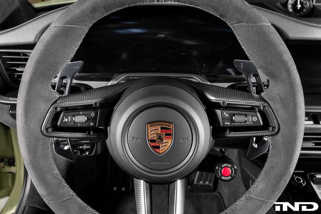 MAED Porsche 911 (992) billet magnetic shift paddle set installed inside the car interior, showing sleek metal design and mounting details.
