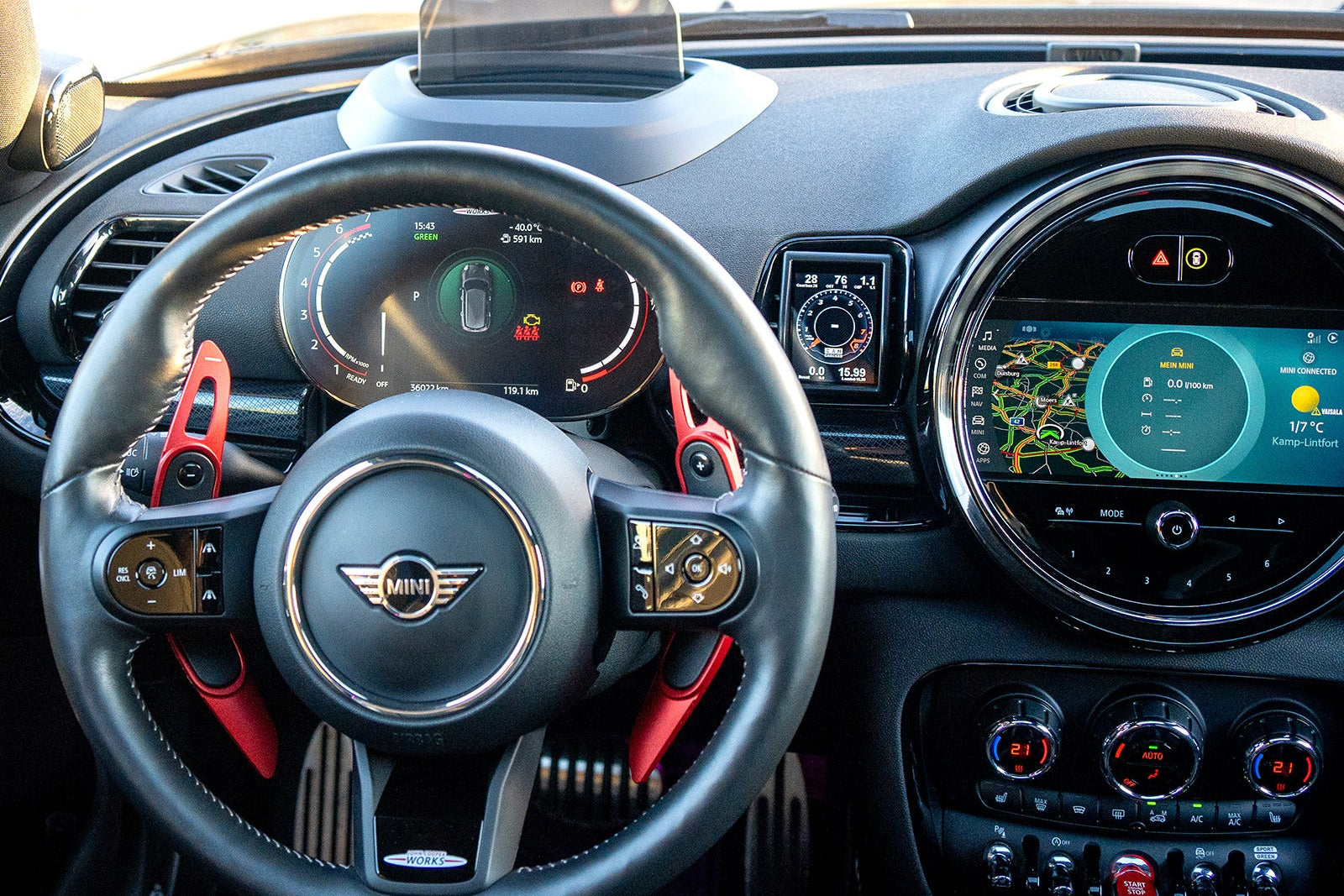 CANchecked MFD28 Gen2 2.8-inch multi-function display installed in a left-hand drive MINI F54 Clubman, featuring a vehicle-specific dashboard integration.