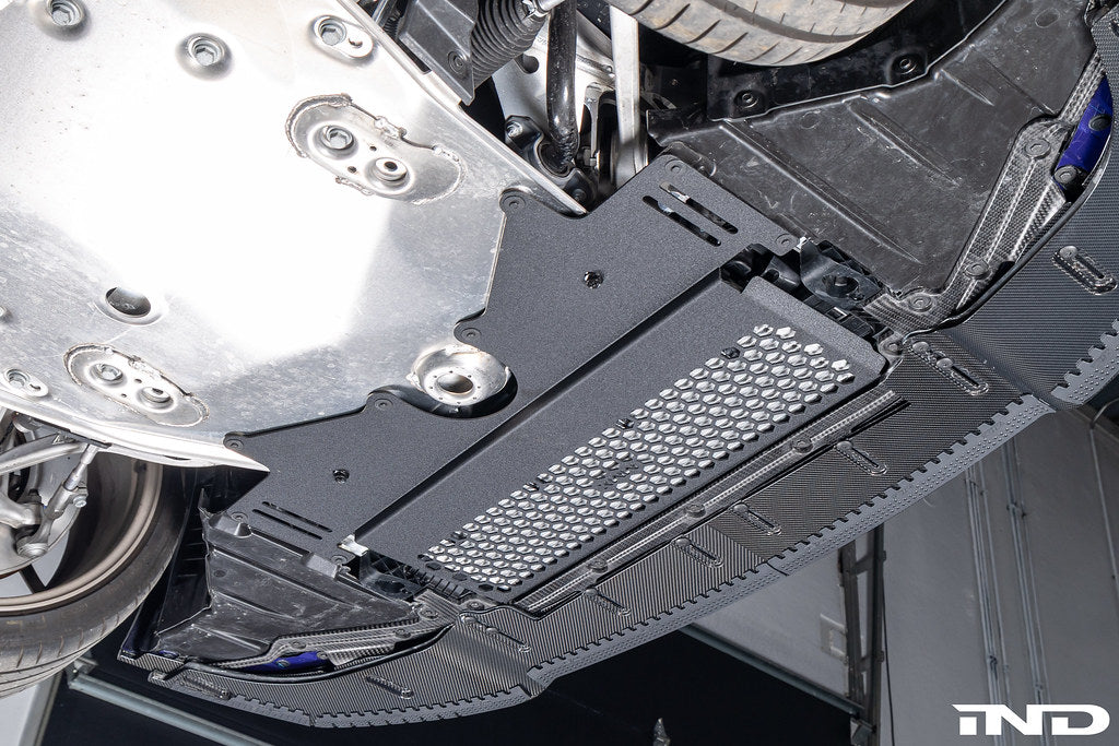 MMX Performance G8X M2 M3 M4 Oil Cooler Guard installed on a BMW G87 M2, G80 G81 M3, or G82 G83 M4, protecting the factory underbody oil cooler from road debris and track hazards while maintaining optimal airflow.