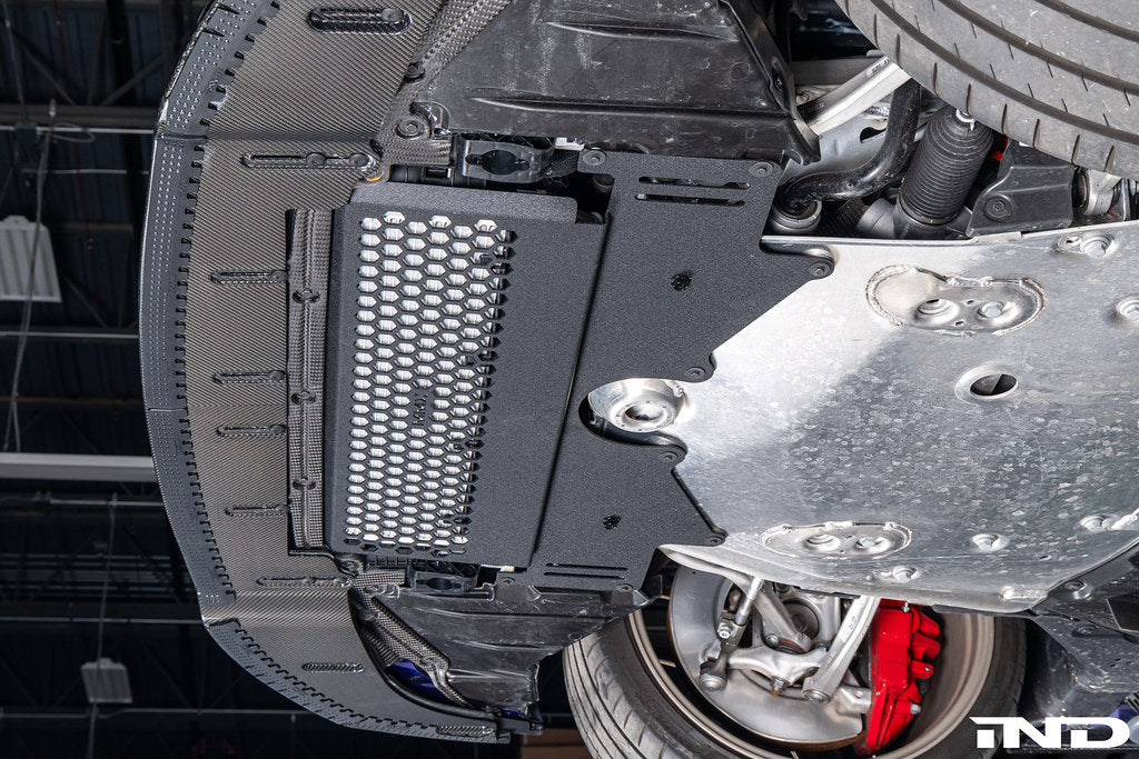 MMX Performance G8X M2 M3 M4 Oil Cooler Guard installed on a BMW G87 M2, G80 G81 M3, or G82 G83 M4, protecting the factory underbody oil cooler from road debris and track hazards while maintaining optimal airflow.