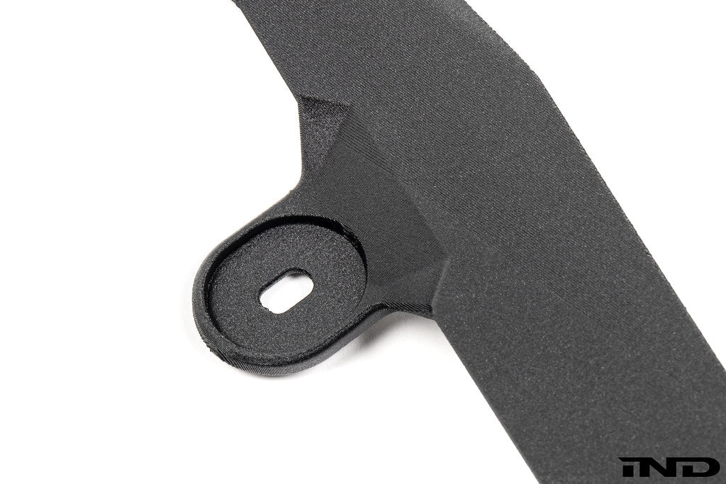 Megachip Aero Line Splash Guard Set for the BMW G87 M2 shown on a white background, featuring a carbon fiber-reinforced composite construction with an OEM+ matte finish for discreet paint protection.