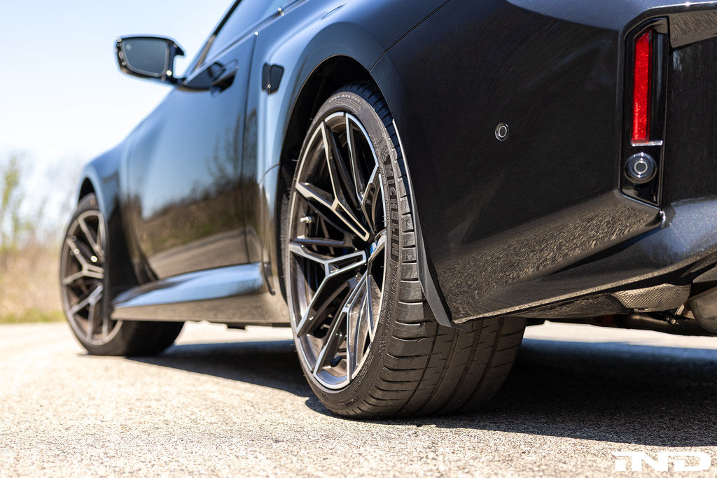Megachip G8X M2 M3 M4 exterior splash guard set installed on vehicle, protecting wheels from mud and debris.