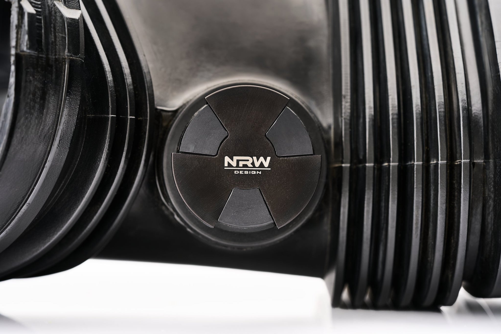 Installed close-up of NRW's BMW S65 machined billet aluminum accessory block off cap.
