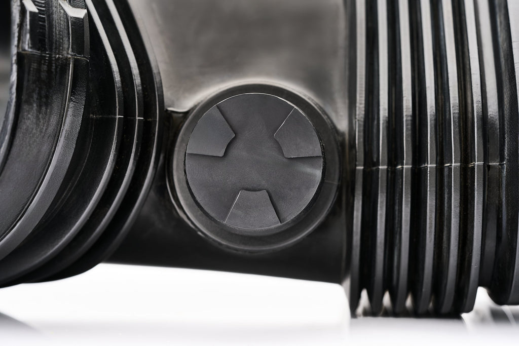 Installed close-up of a factory OE BMW plastic S65 accessory block off cap.