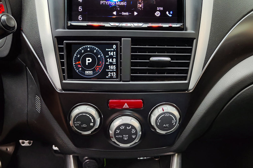CANchecked MFD32 Gen2 3.2-inch multi-function display installed in a left-hand drive Subaru GR Impreza WRX (MK3), featuring a vehicle-specific dashboard integration.