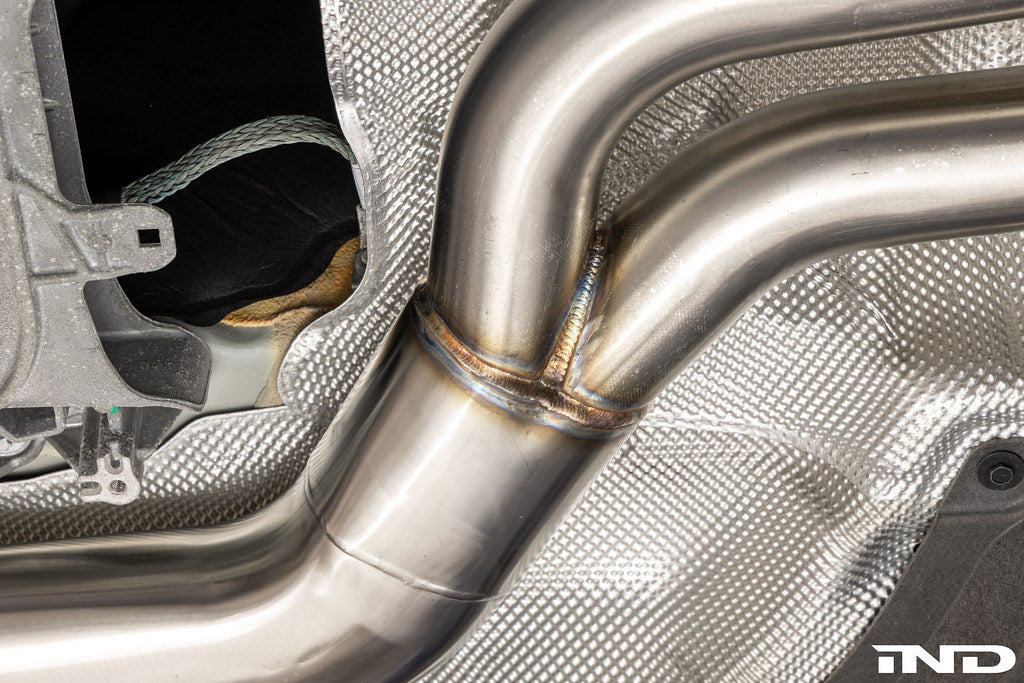 Supersprint J-pipe resonator delete package installed on a BMW G87 M2 with the factory OEM muffler, designed to deliver a more aggressive exhaust note while maintaining OEM fitment and compatibility.