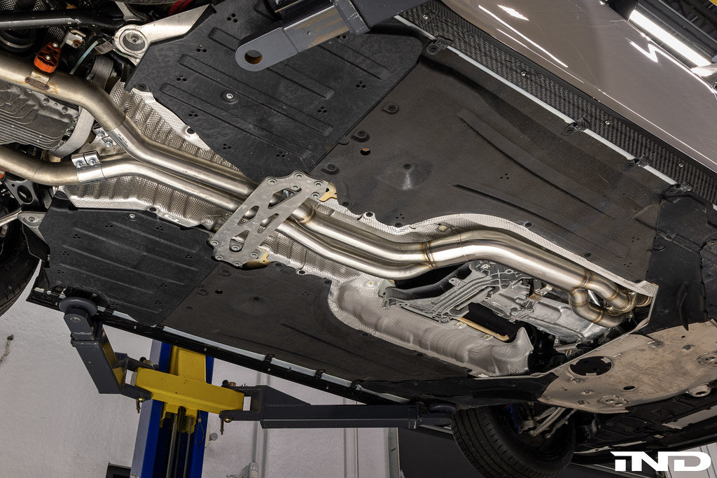Supersprint J-pipe resonator delete package installed on a BMW G87 M2 with the factory OEM muffler, designed to deliver a more aggressive exhaust note while maintaining OEM fitment and compatibility.