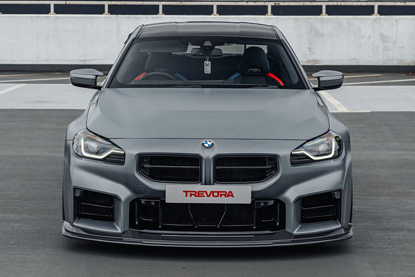 TREVORA G87 M2 TR87 Track Pre-Preg Carbon Fibre Front Splitter installed on a BMW G87 M2, featuring a motorsport-inspired pre-preg carbon fibre design engineered to increase front-end downforce, aerodynamic balance, and high-speed stability.