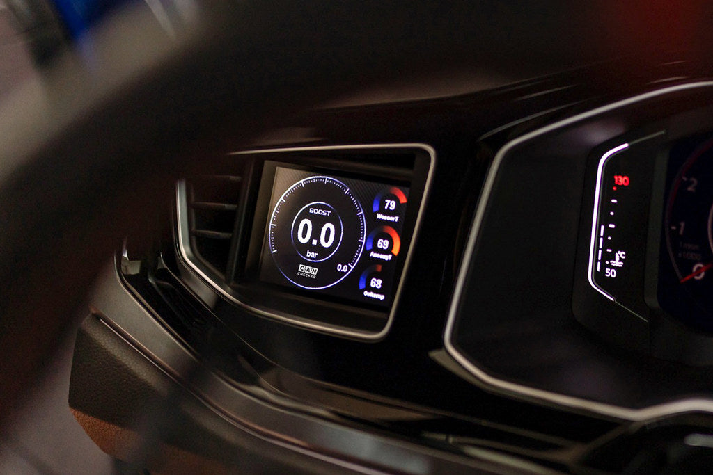 CANchecked MFD32 Gen2 3.2-inch multi-function display installed in a left-hand drive Volkswagen MK6 Polo, featuring a vehicle-specific dashboard integration.