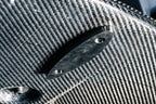 Vulcan Alpha G8X M3 M4 carbon front splitter on a car's exterior, showcasing aerodynamic design and high-performance materials.