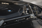 AptusWorks ACX A90 A91 MKV Supra DMLS carbon strut brace installed in engine bay for enhanced suspension stability.