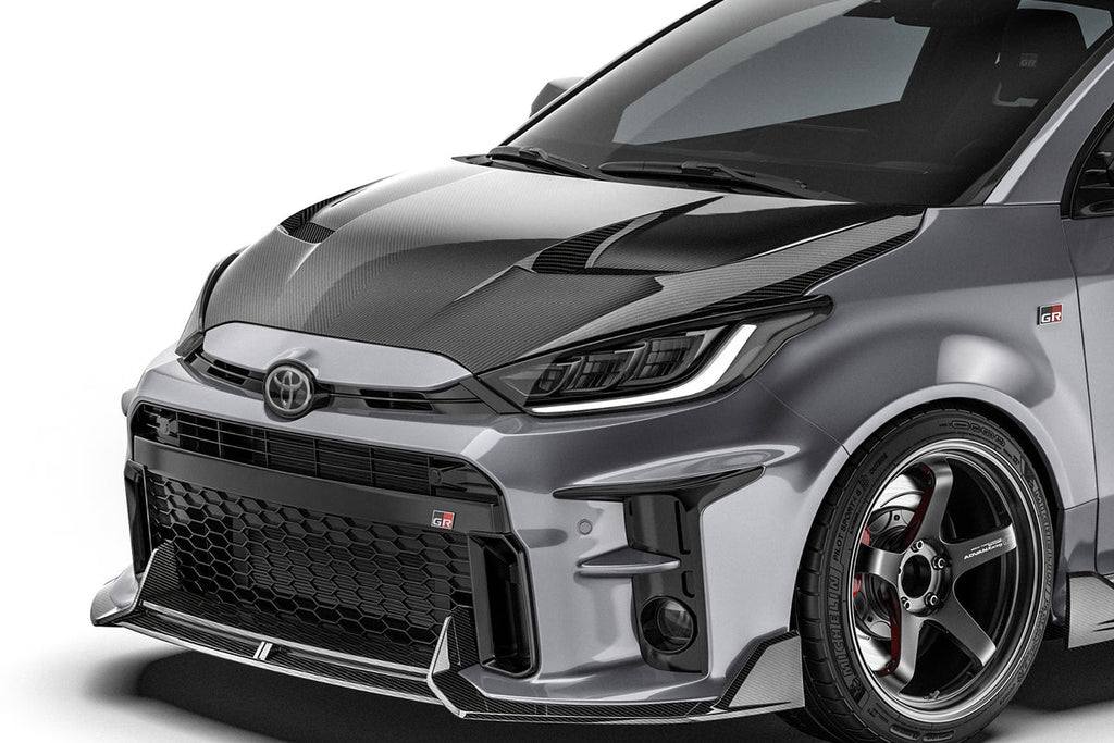 ADRO carbon fiber front lip installed on Toyota GR Yaris, showcasing sleek exterior design and aerodynamic enhancement.