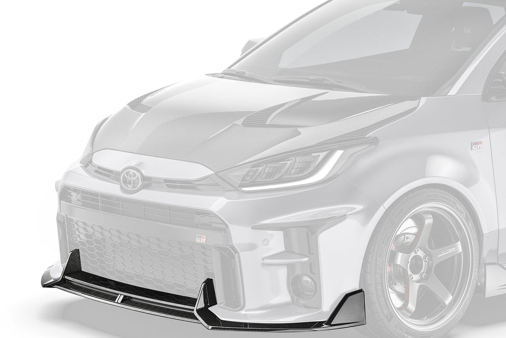 ADRO Toyota GR Yaris carbon fiber front lip installed, showcasing its sleek exterior design and aerodynamic enhancement from an angled view.
