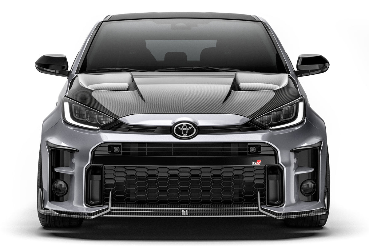 ADRO Toyota GR Yaris with carbon fiber front lip installed, showcasing sporty exterior upgrade on the front bumper.