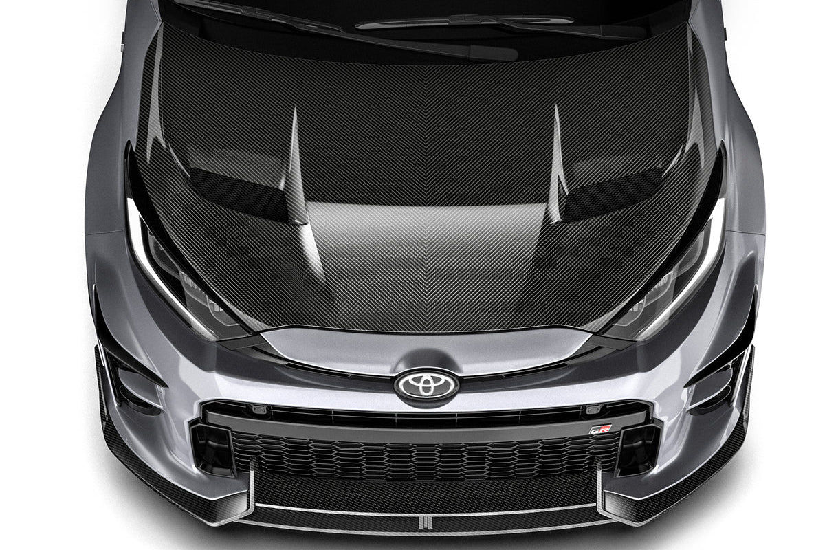 ADRO carbon fiber front lip installed on a Toyota GR Yaris, enhancing the vehicle's sporty exterior appearance.