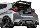ADRO Toyota GR Yaris exterior carbon fiber spoiler installed, showcasing its sleek, lightweight design from an angled view.