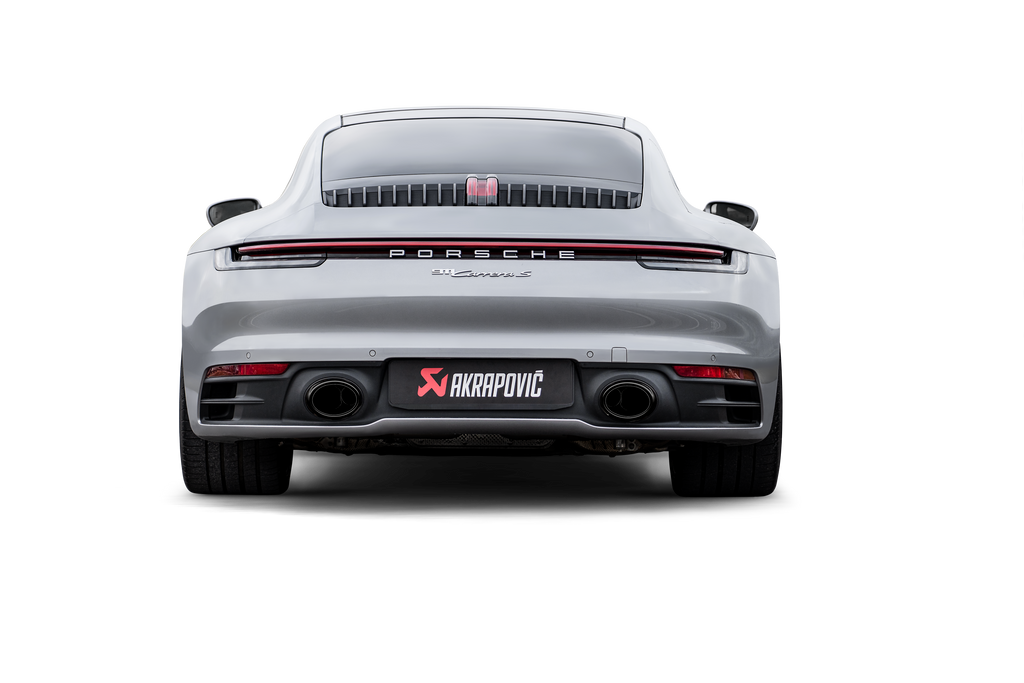 Akrapovič Porsche 992.1 Carrera GTS Dakar slip-on race exhaust with black tailpipes installed on the vehicle.