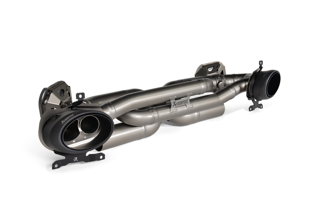 Akrapovič Porsche 992.1 Carrera GTS Dakar Slip-On Race Exhaust, black titanium finish, mounted on vehicle engine bay.