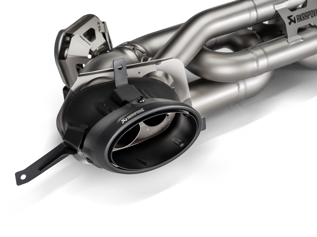 Akrapovič Porsche 992.2 Carrera T Slip-On Line exhaust system components, showcasing stainless steel pipes and muffler details.
