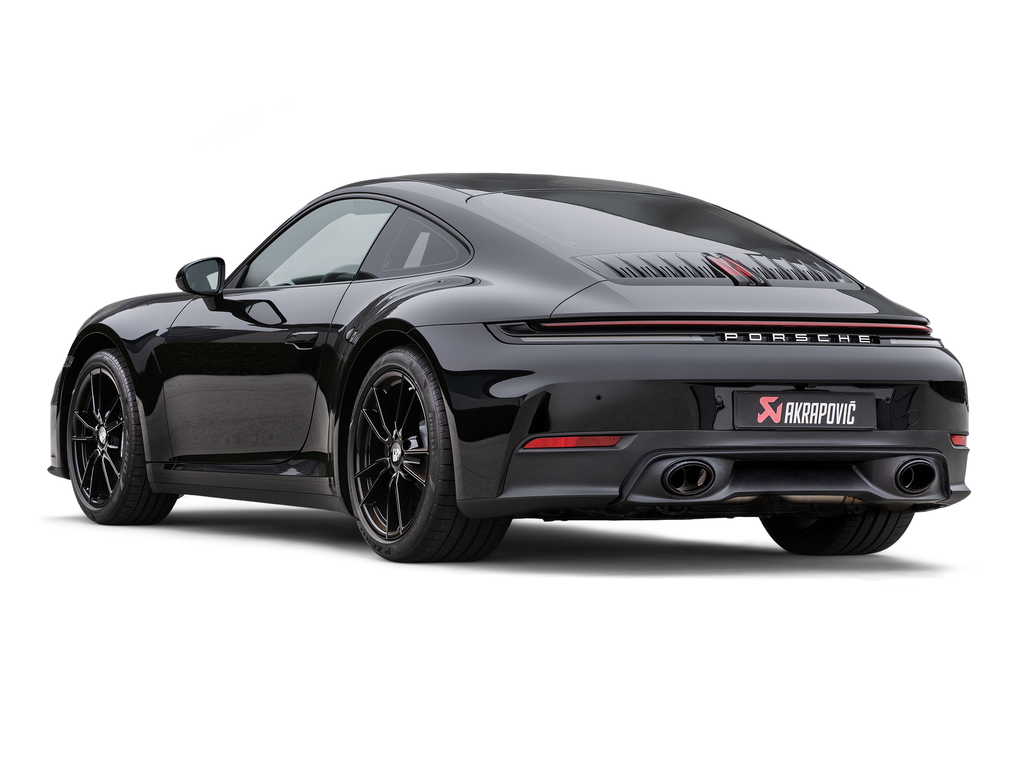 Akrapovič Porsche 992.2 Carrera T slip-on exhaust system with valve, showcasing polished metal and branding details.