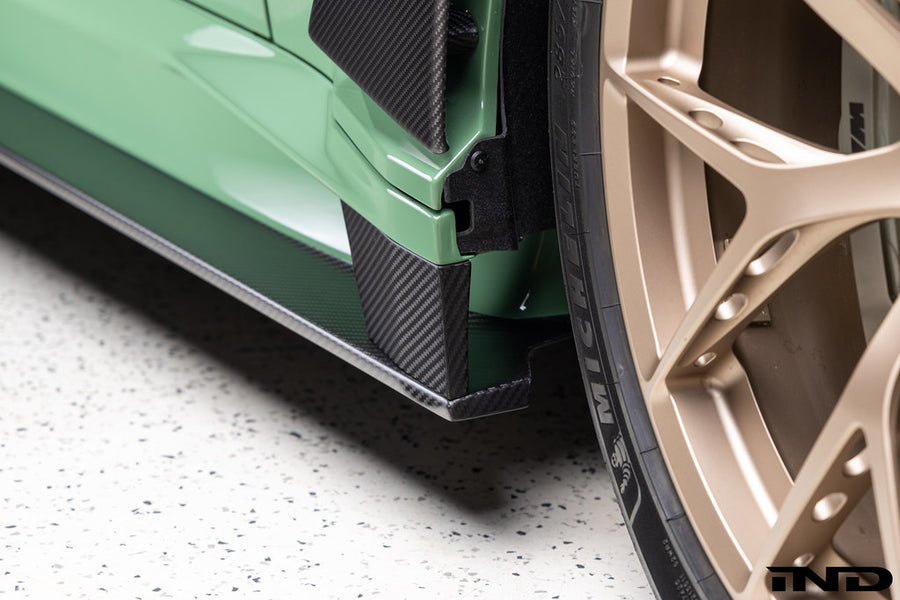Alpha-N carbon fiber full replacement side skirts installed on a BMW G87 M2.