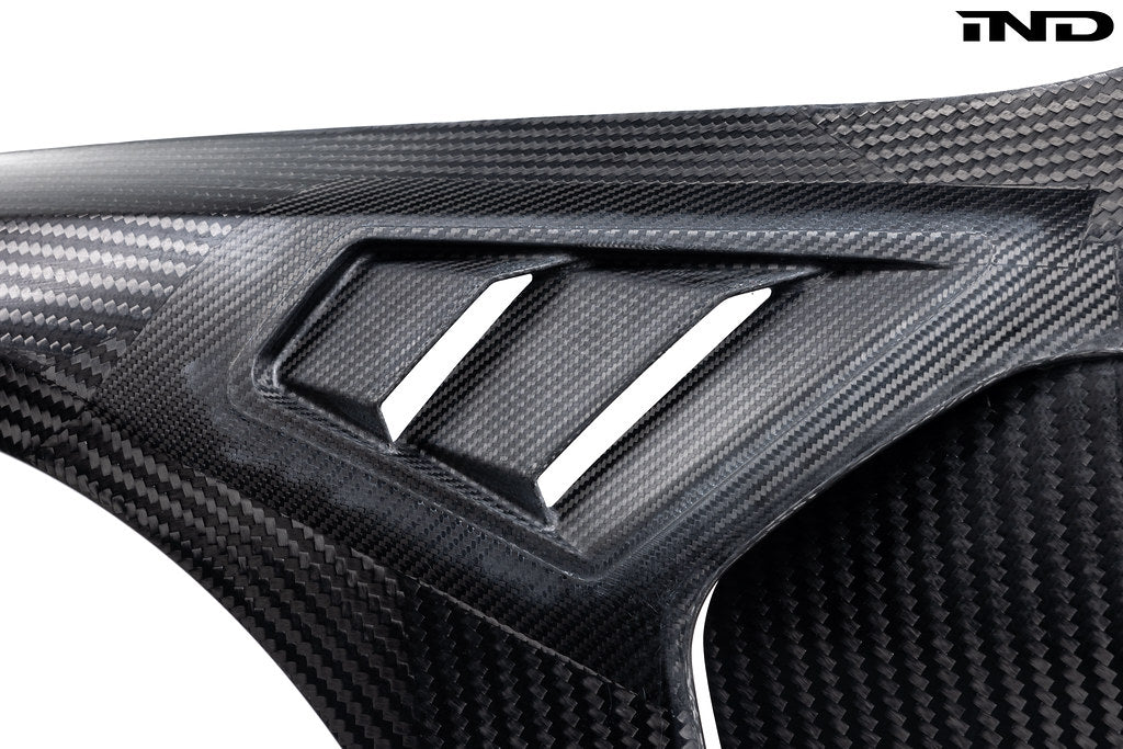 Alpha N carbon vented front fender set for BMW G8X M3 and M4, with a sleek exterior design on a white background.