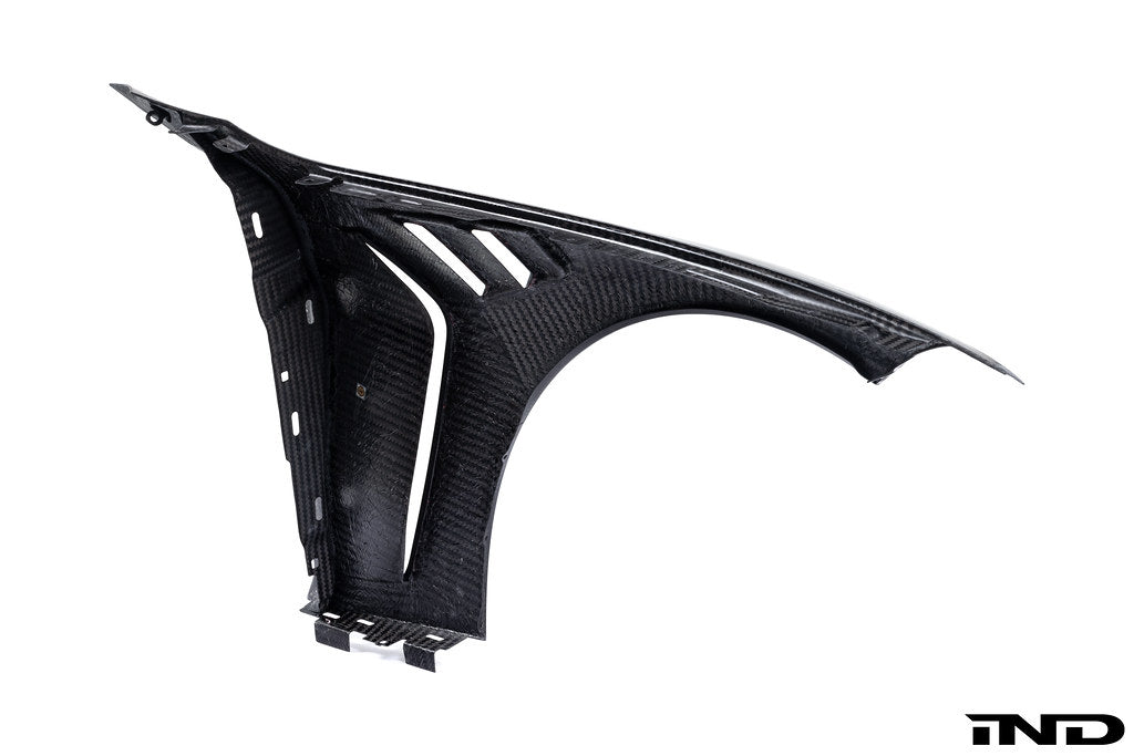 Alpha N G8X M3 M4 carbon vented front fender set installed on white background, showcasing exterior automotive body parts.