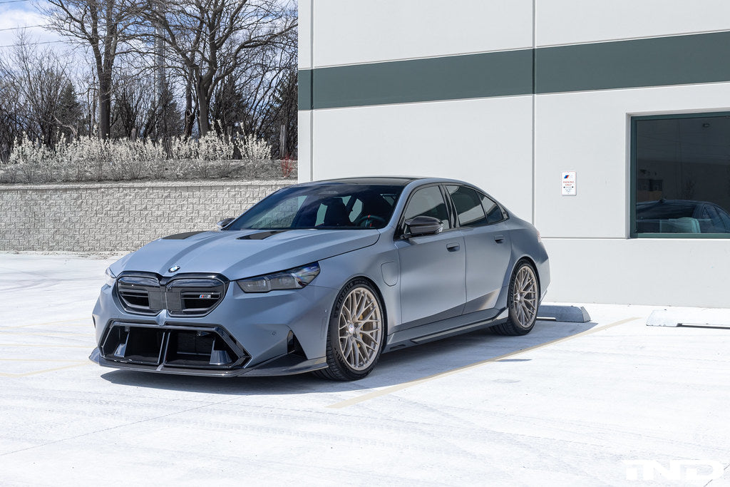 Alpha N G90 G99 M5 carbon front splitter set installed on a car, showcasing three-piece exterior aerodynamic enhancement.