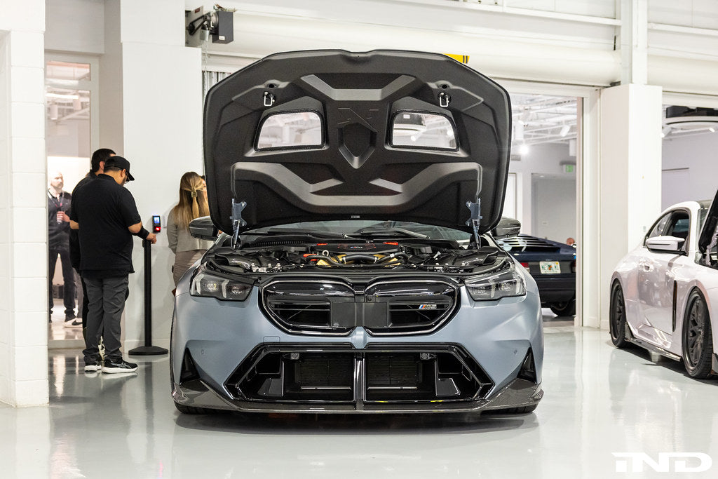 Alpha N BMW G90 G99 M5 carbon front splitter set, three-piece exterior upgrade with aerodynamic design installed on vehicle