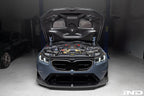 Alpha-N BMW G90 G99 M5 carbon front splitter set installed, three-piece exterior upgrade for enhanced aerodynamics and sporty look.