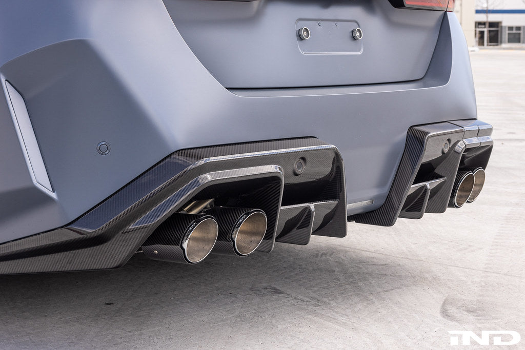 Alpha N G90 G99 M5 Carbon Rear Diffuser V2 installed on a BMW, showcasing its sleek, aerodynamic exterior design.