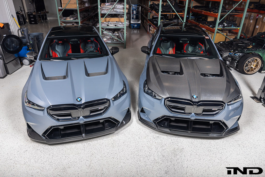 Alpha N BMW G90 G99 M5 carbon vented hood installed on the exterior of the vehicle, showcasing sporty design and venting features.