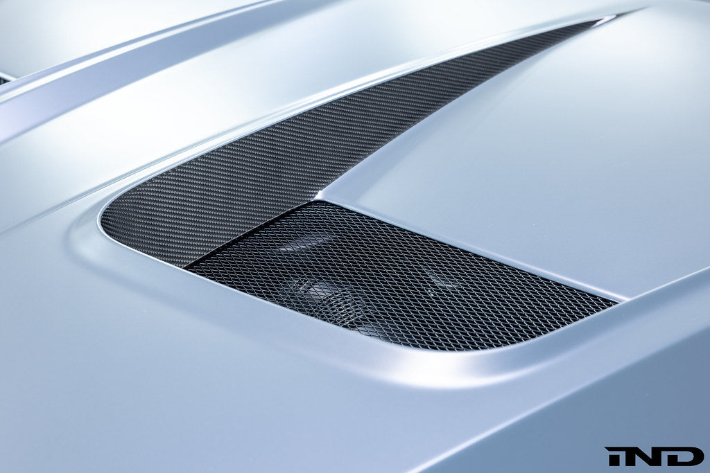 Alpha N BMW G90 G99 M5 carbon vented hood installed on exterior of vehicle, showcasing lightweight performance and sleek design.