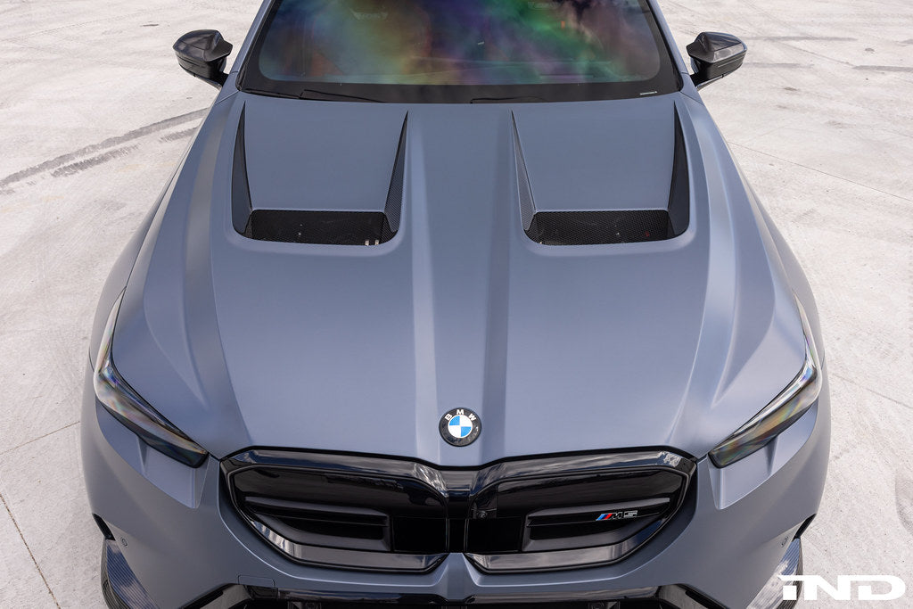 Alpha N BMW G90 G99 M5 carbon vented hood installed, showcasing lightweight, aerodynamic exterior design for enhanced performance.