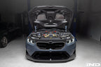 Alpha N BMW G90 G99 M5 carbon vented hood installed, showcasing sleek exterior design and lightweight carbon fiber construction.
