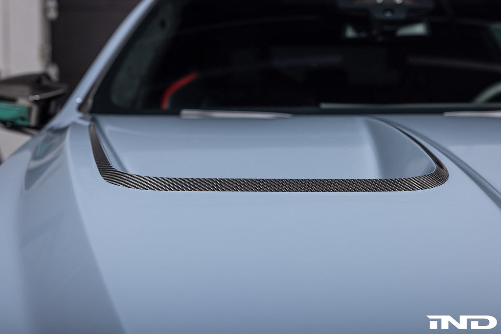 Alpha N BMW G90 G99 M5 carbon vented hood installed, showcasing its sleek vented exterior design and lightweight carbon construction.