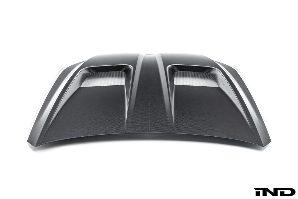 Alpha-N BMW G90 G99 M5 carbon vented hood, exterior view showcasing lightweight design and vented panels on a white background.