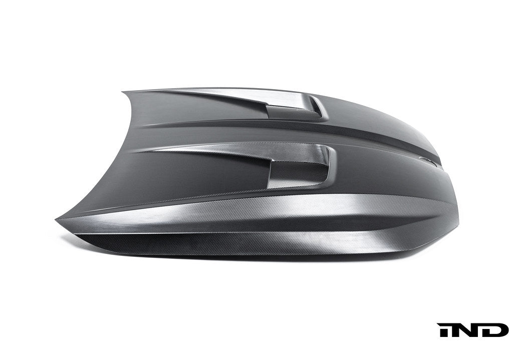 Alpha N BMW G90 G99 M5 carbon vented hood installed on vehicle, showcasing lightweight exterior design with vents for improved airflow.