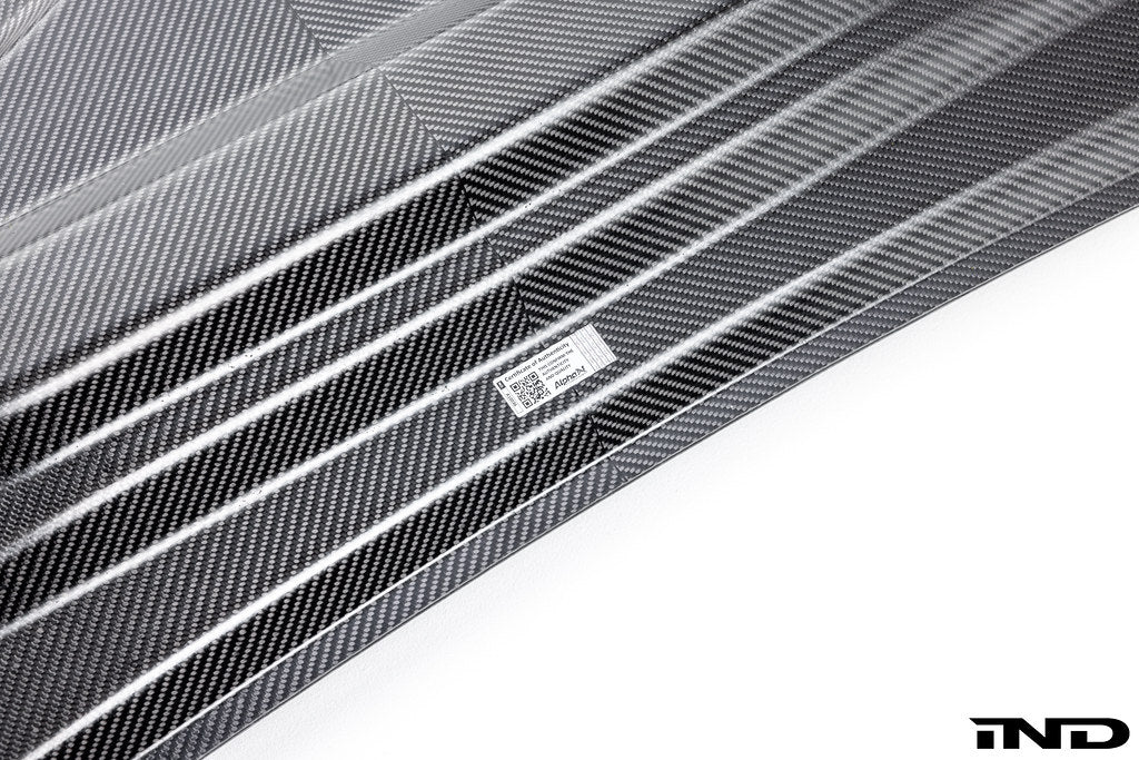 Alpha N BMW G90 G99 M5 carbon vented hood displayed on a white background, showcasing its sleek exterior design and venting details.