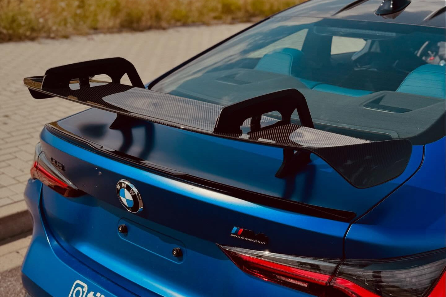 Alpha N Carbon SN rear wing installed on BMW M2, M3, M4 showcasing aerodynamic exterior performance.