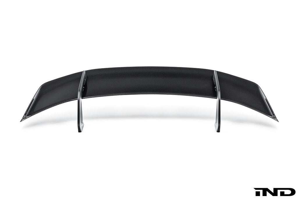Alpha N Alpha-N Carbon SN rear wing mounted on a vehicle, showcasing its sleek white exterior design and aerodynamic features.