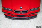 Alpha N E36 M3 Carbon GT front lip installed on red BMW E36 M3, showcasing sleek exterior automotive styling.