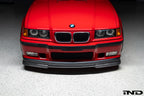 Alpha N E36 M3 Carbon GT front lip installed on red E36 M3, showcasing exterior automotive styling and aerodynamic enhancement.